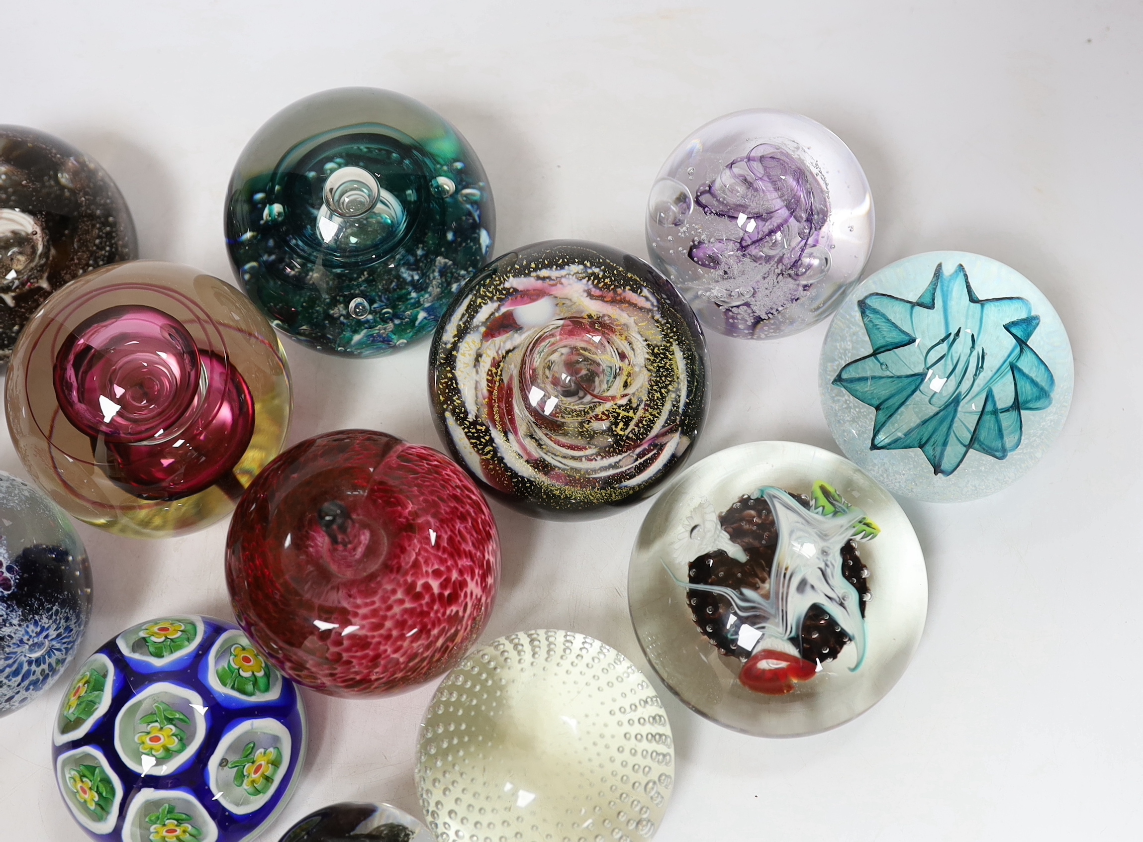 Thirteen glass paperweights including Caithness and Murano, largest 9cm in diameter